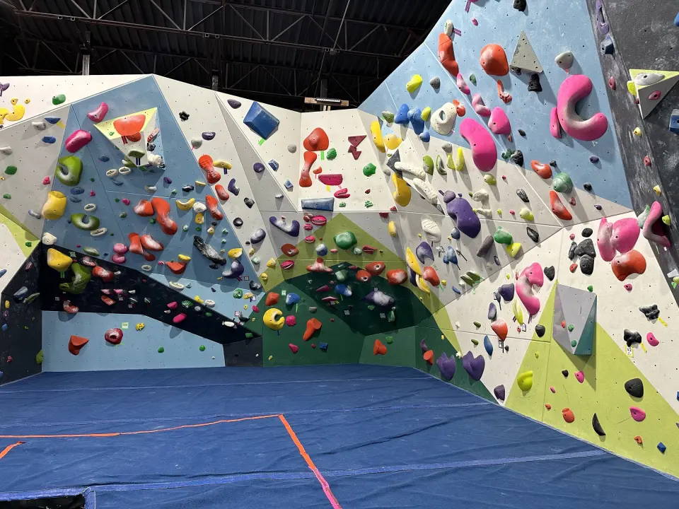 Bouldering walls and blue matting in the main climbing hall