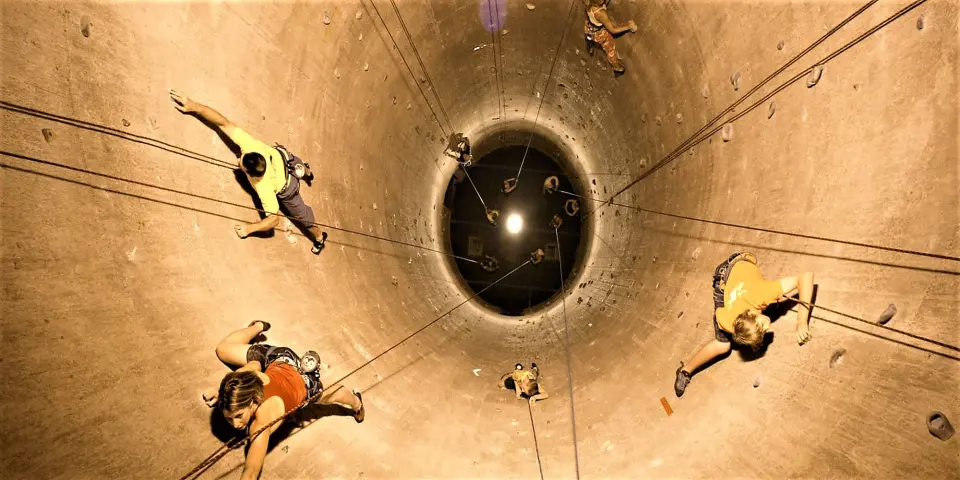 Climbers on ropes inside one of the 65 ft grain silos, seen from below