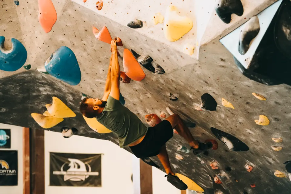 Boulderer on a steep overhang during the Coney Classic