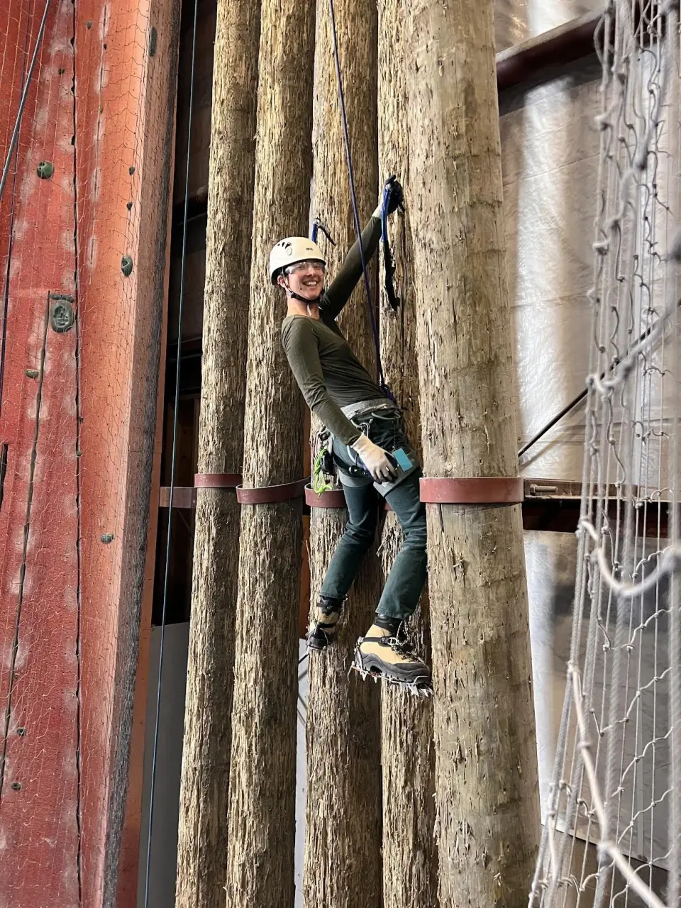 Ice climber with axes and crampons on the wooden poles