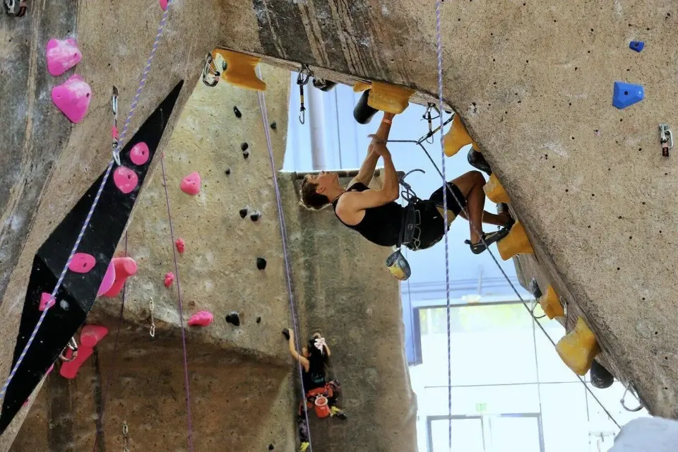 Lead climber pulling through the roof of the lead cave
