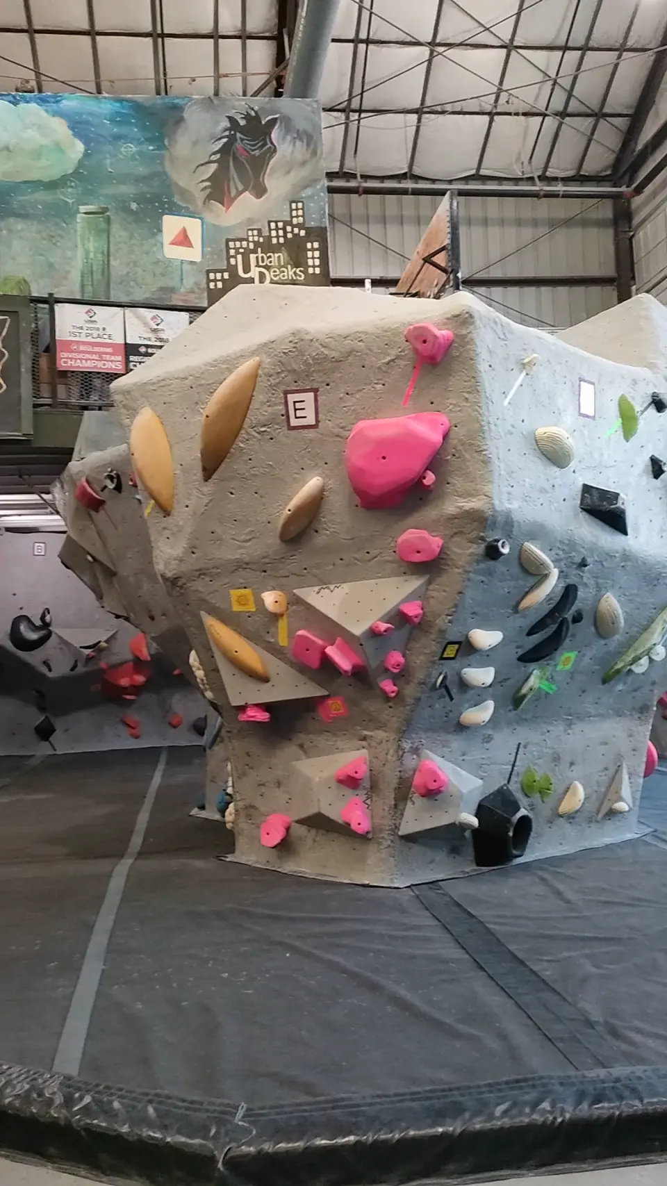 Free-standing boulder in front of a skyline mural