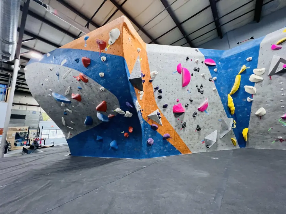 The Tsunami bouldering wall in blue, orange and grey
