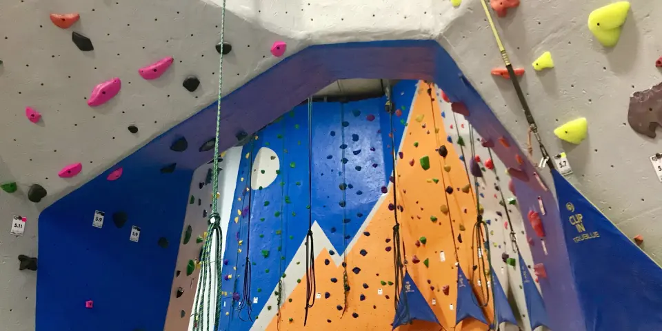 Top-rope lines and auto-belays inside the painted arch