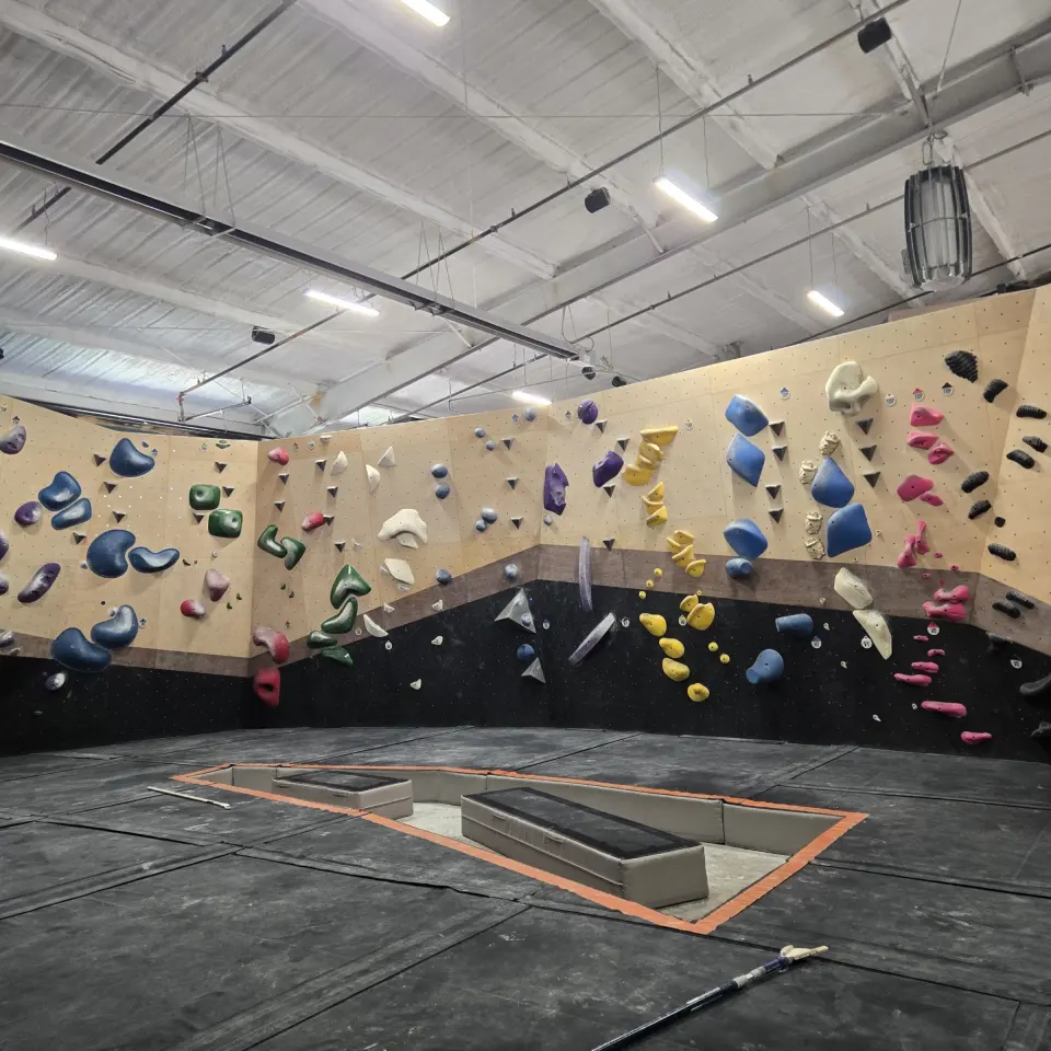 Long bouldering wall around a central matted area