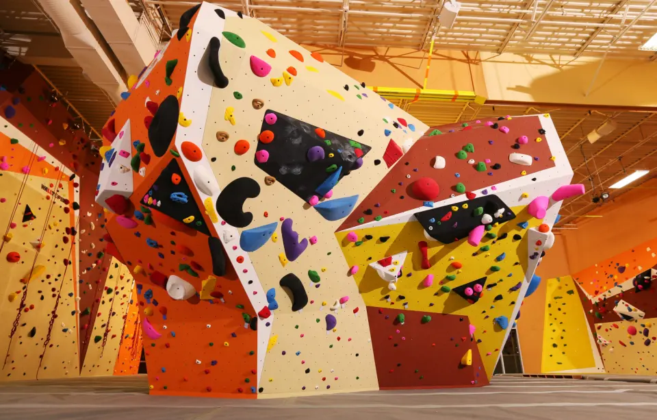 Angular bouldering walls with orange, white and yellow panels