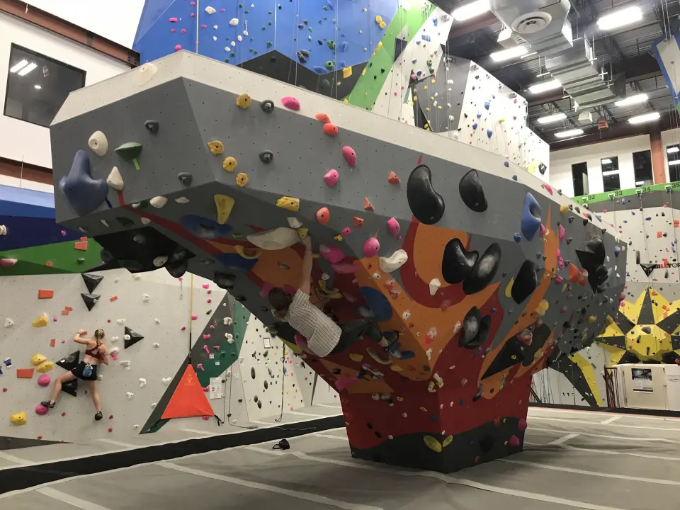 Large free-standing boulder with orange and blue overhangs