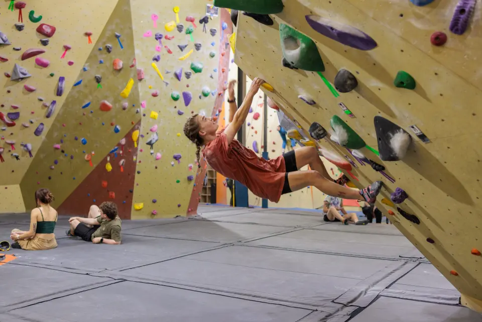 Climber on a steep bouldering wall