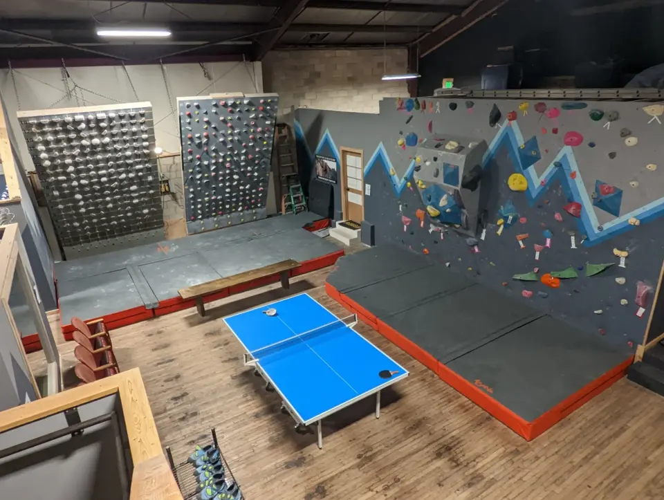 Bouldering room with the MoonBoard, Tension Board and ping-pong table
