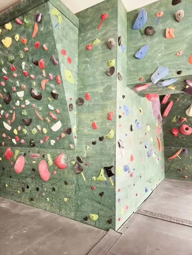 Arete and corner walls covered in colourful holds