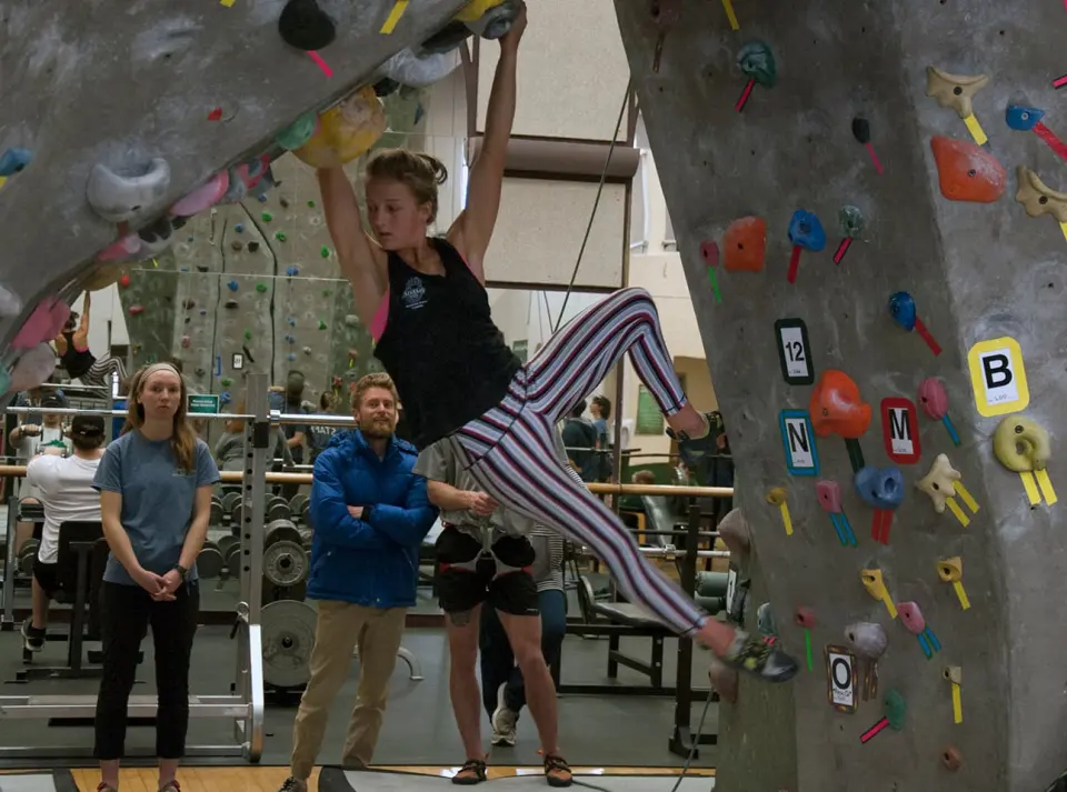 Competitor on a roped route during a climbing competition at the Rex