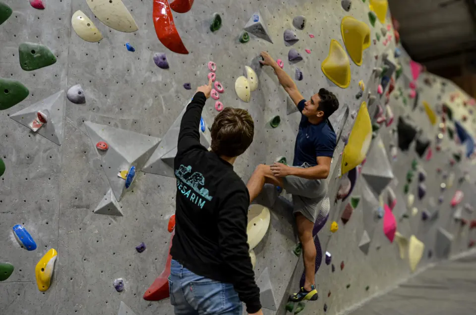 Climbers on a bouldering wall during a class