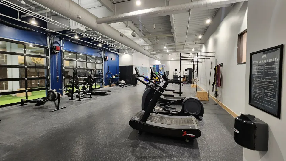 Fitness area with racks and cardio machines