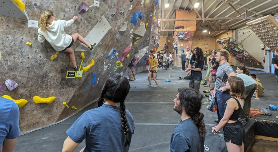 Climbers watching a boulderer on the steep main wall
