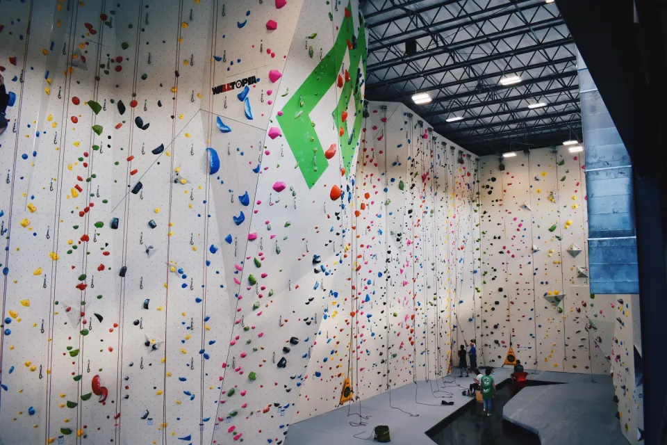 Tall white roped walls lined with colourful holds