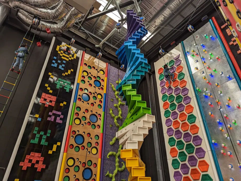 Challenge walls with coloured holds beside the spiralling Stairway climb