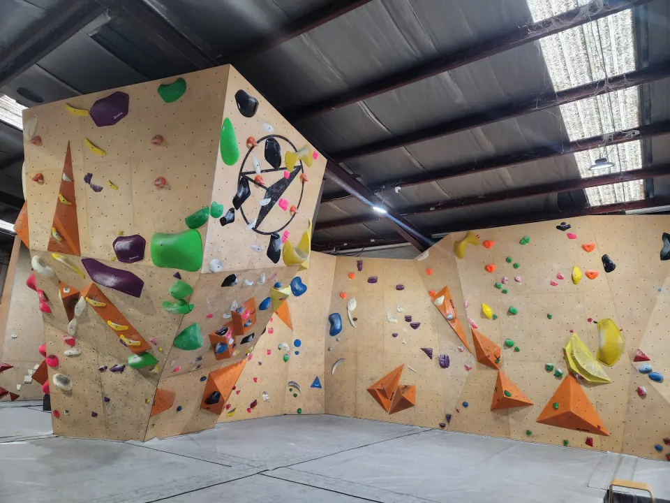The prow with the Flow logo and the bouldering walls around the warehouse