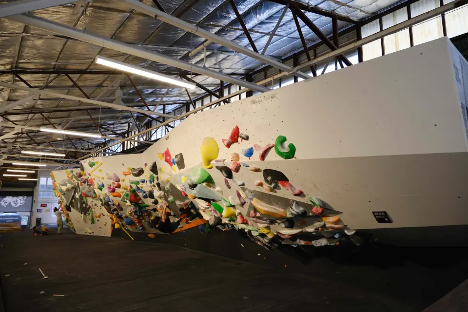 Long overhanging bouldering wall packed with holds in the Twostead building