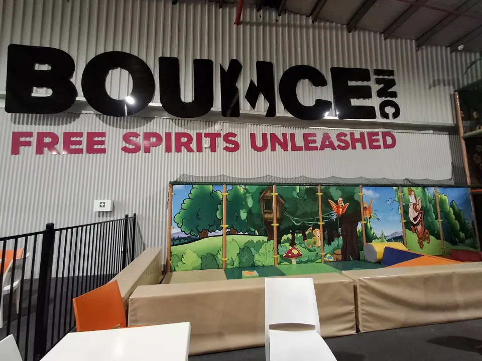 Café seating below the BOUNCE sign