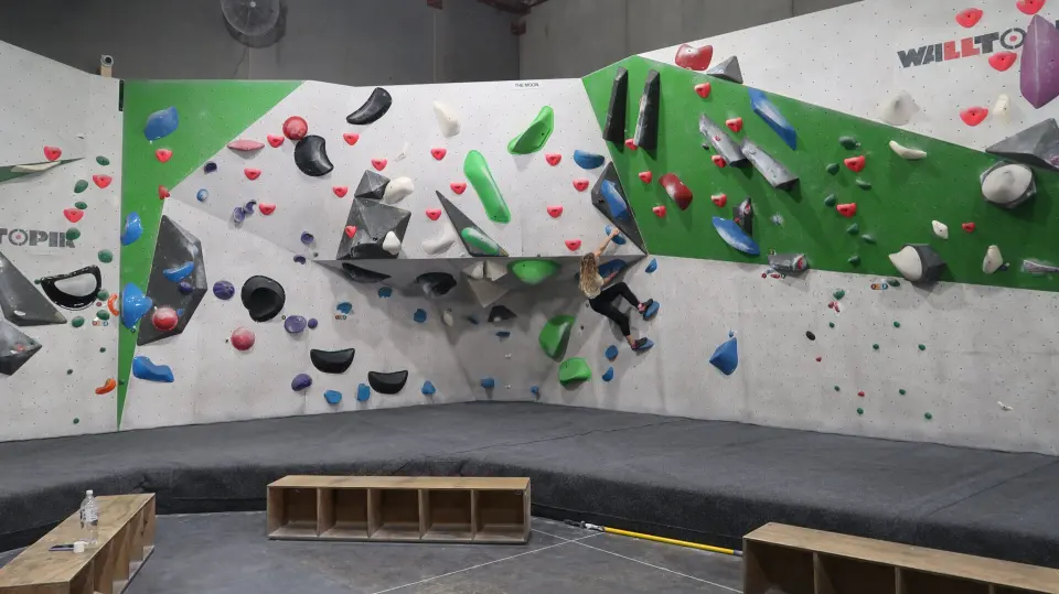 White and green bouldering walls of The Moon sector above deep matting
