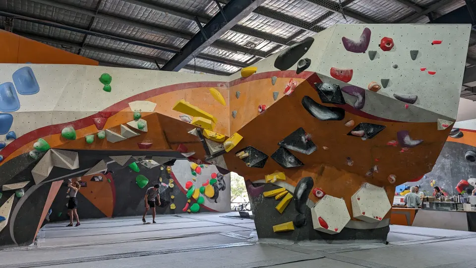 Orange and white overhanging boulders across the main hall