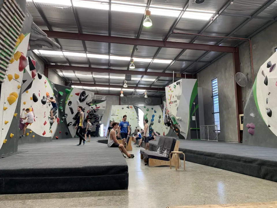 Climbers resting between problems in the bouldering hall