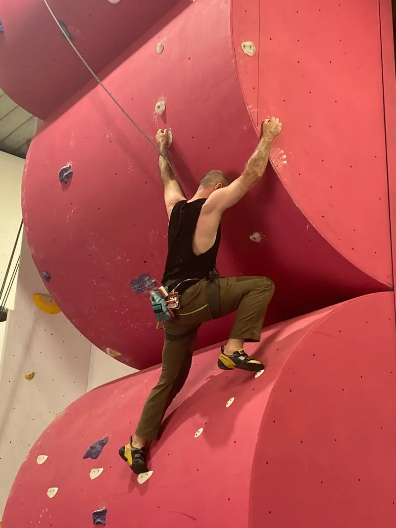 Climber on the big pink curved feature