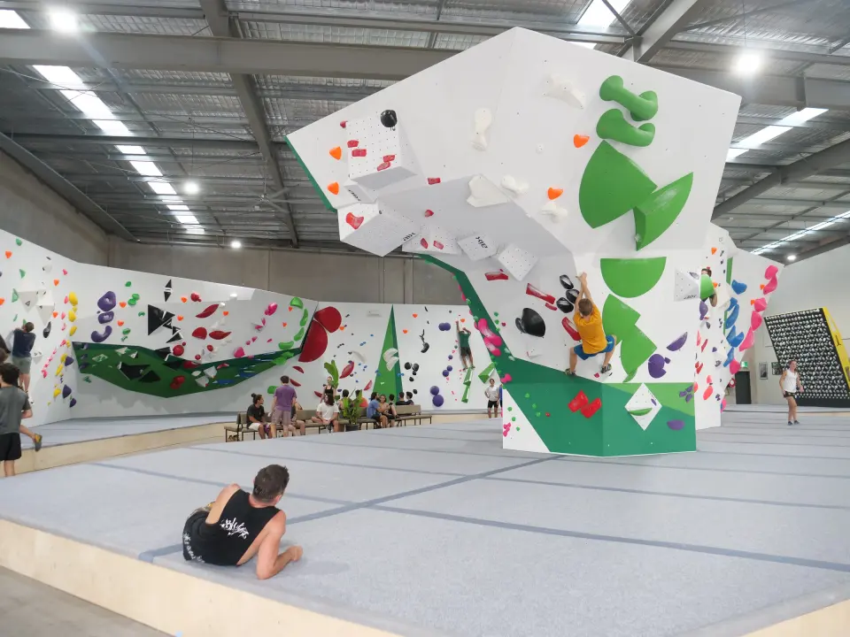 Climbers on the central prow boulder and the surrounding bouldering walls