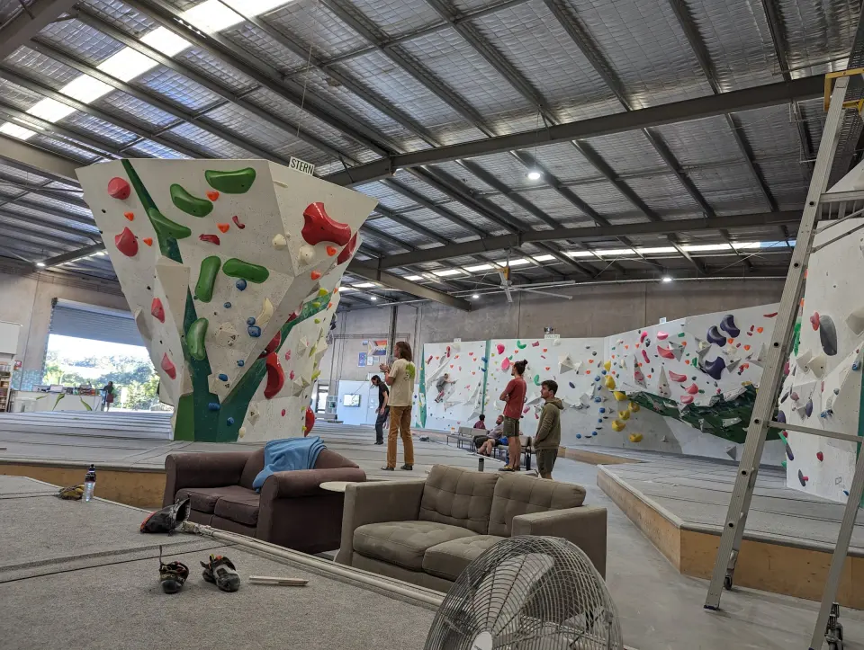 Sofas in front of the prow and the long bouldering wall
