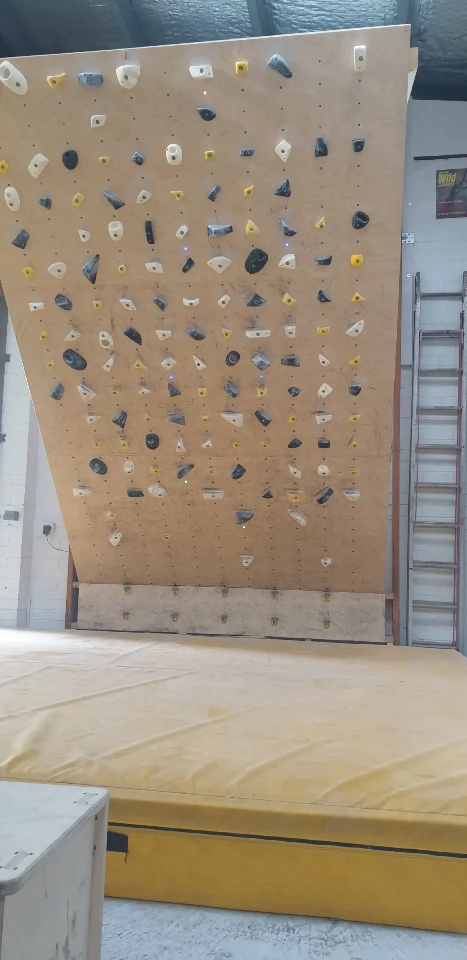Wooden training board with a grid of holds