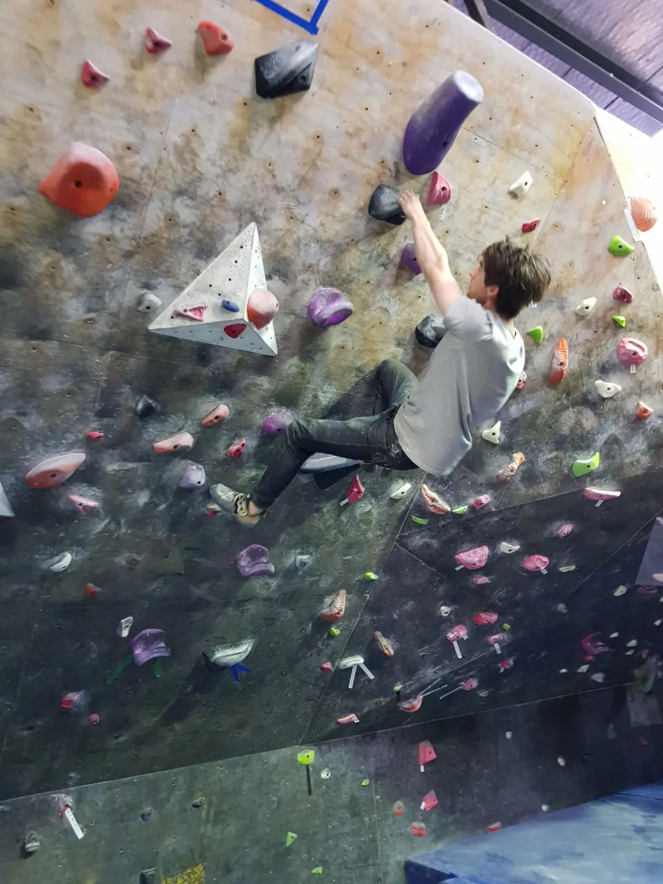 Climber on an overhanging bouldering wall