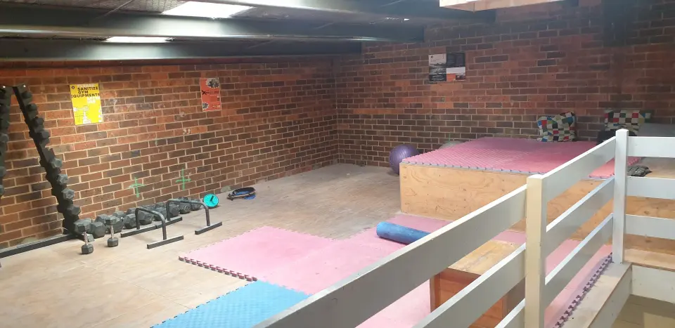 Upstairs training area with weights and floor mats