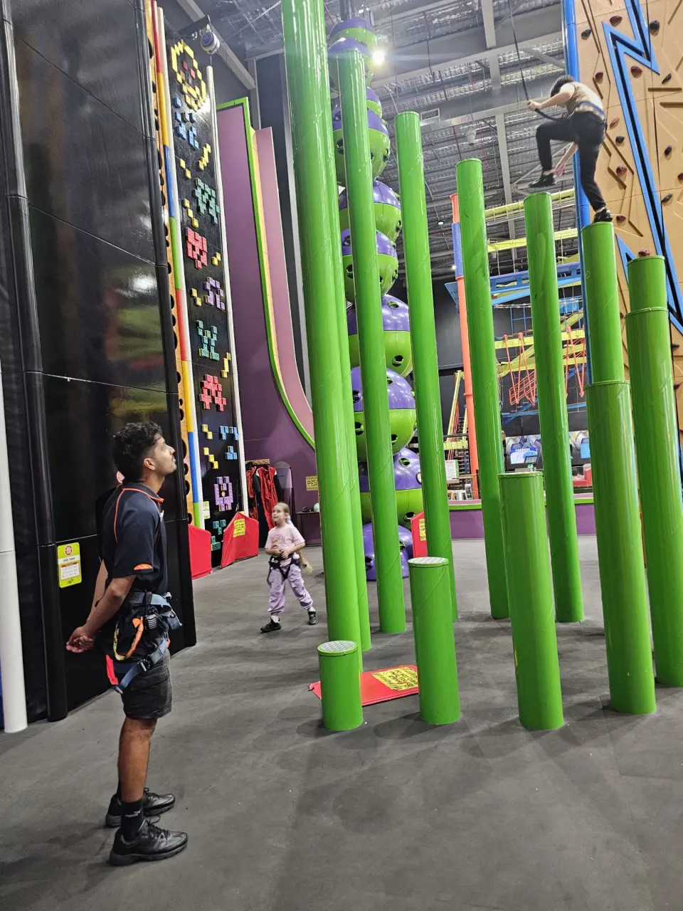 Green step-up poles in front of the tall Clip 'n Climb walls