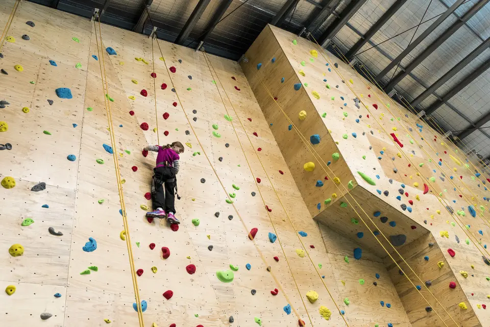 Climber on top rope beside the angled feature of the wall