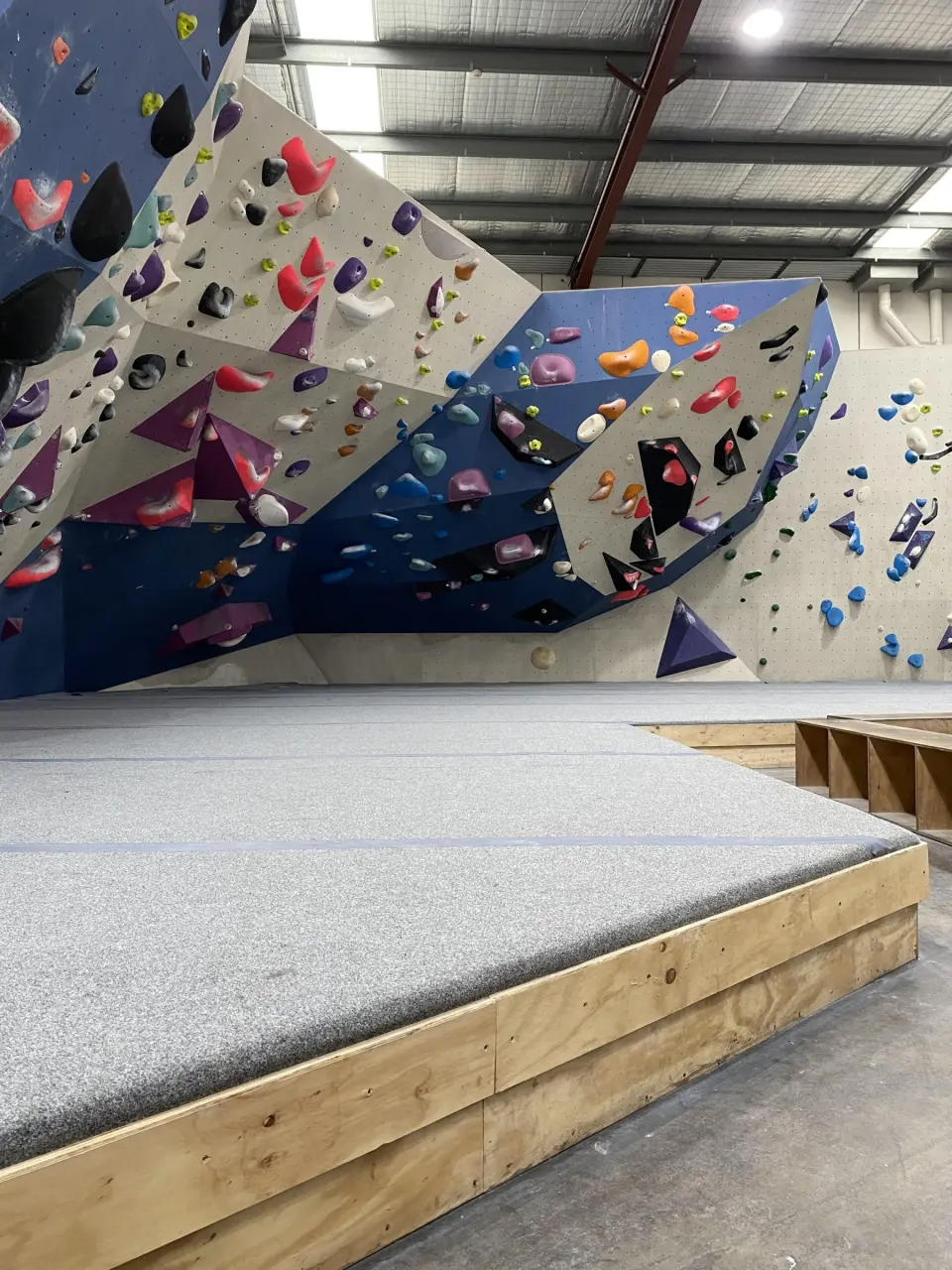 Angled bouldering walls above deep crash mats
