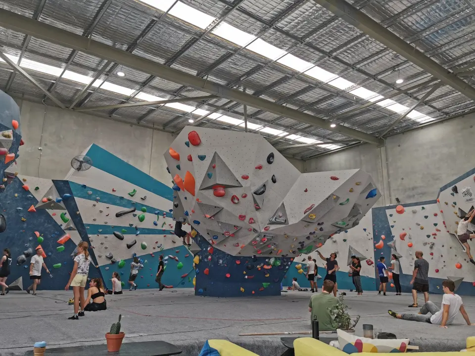 Climbers below the Whale Tail prow and the painted sunburst wall