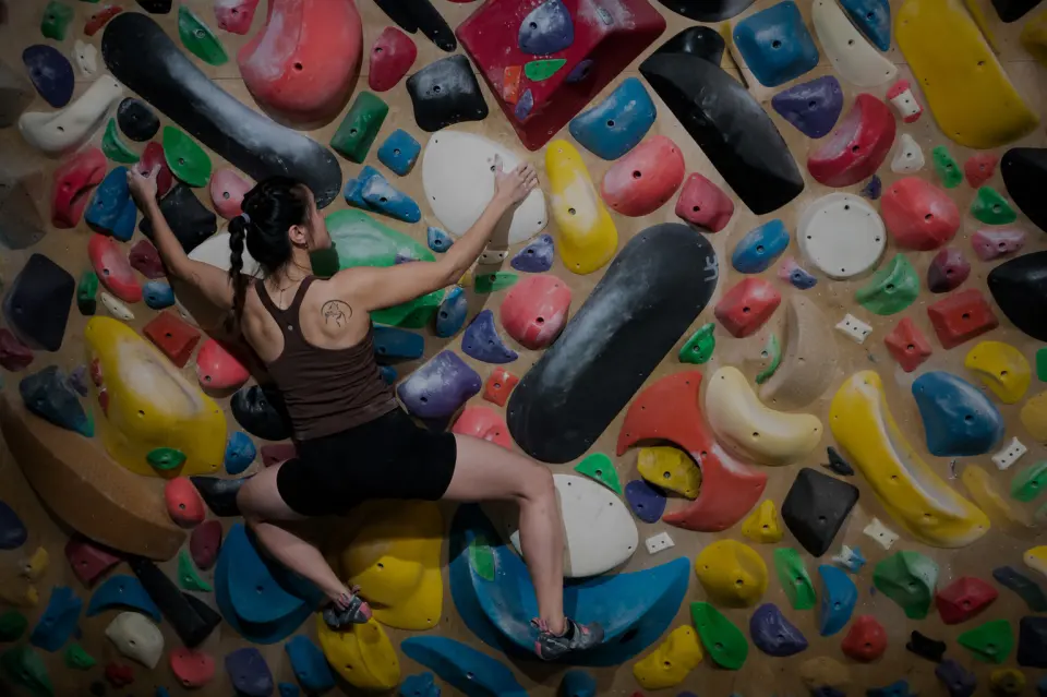 Climber on the colourful spray wall