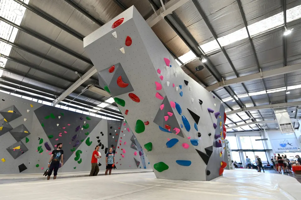 Stepped freestanding boulder above white matting in the main hall
