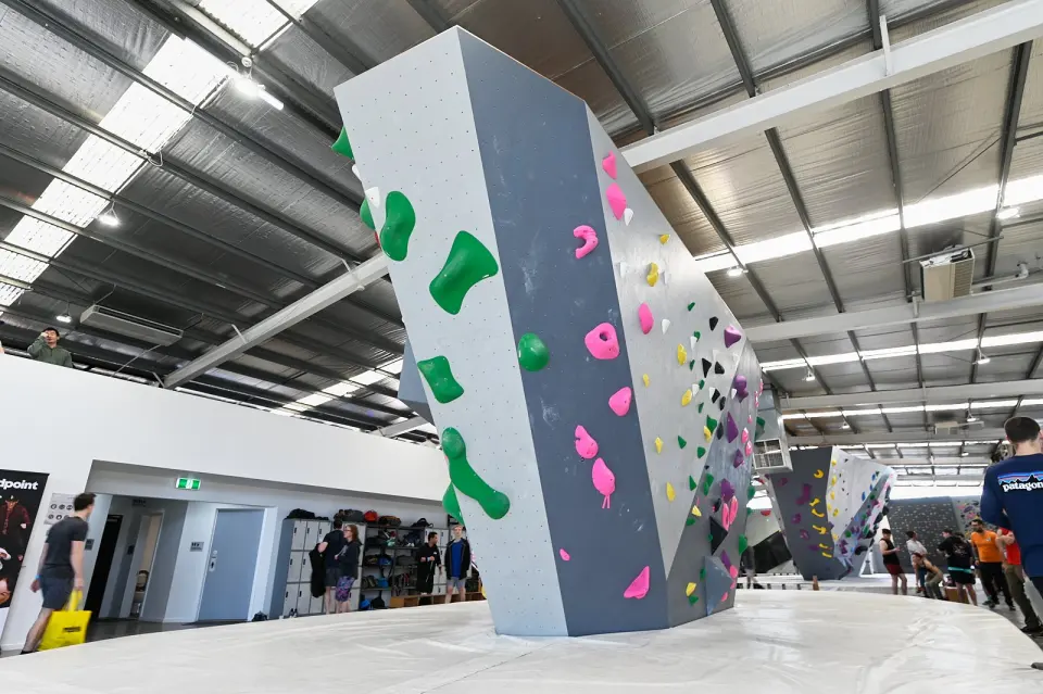 Tall grey boulder pillar near the front desk and lockers