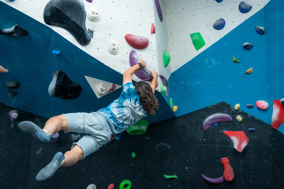 Climber pulling through the steep black section of the wall