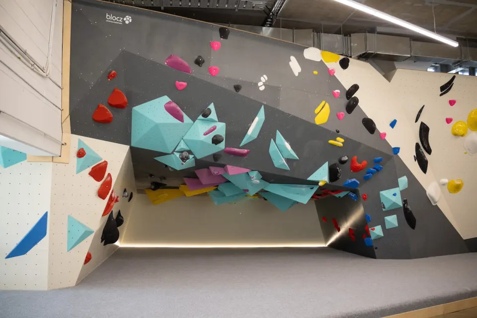 Steep overhang lit by a strip light along its base
