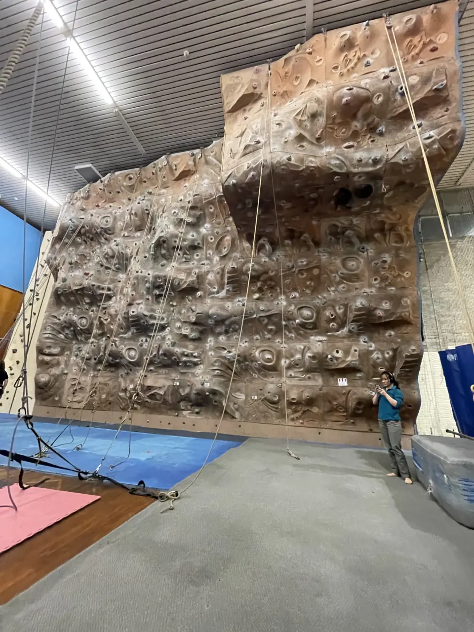 The textured wall rising to an overhanging top section