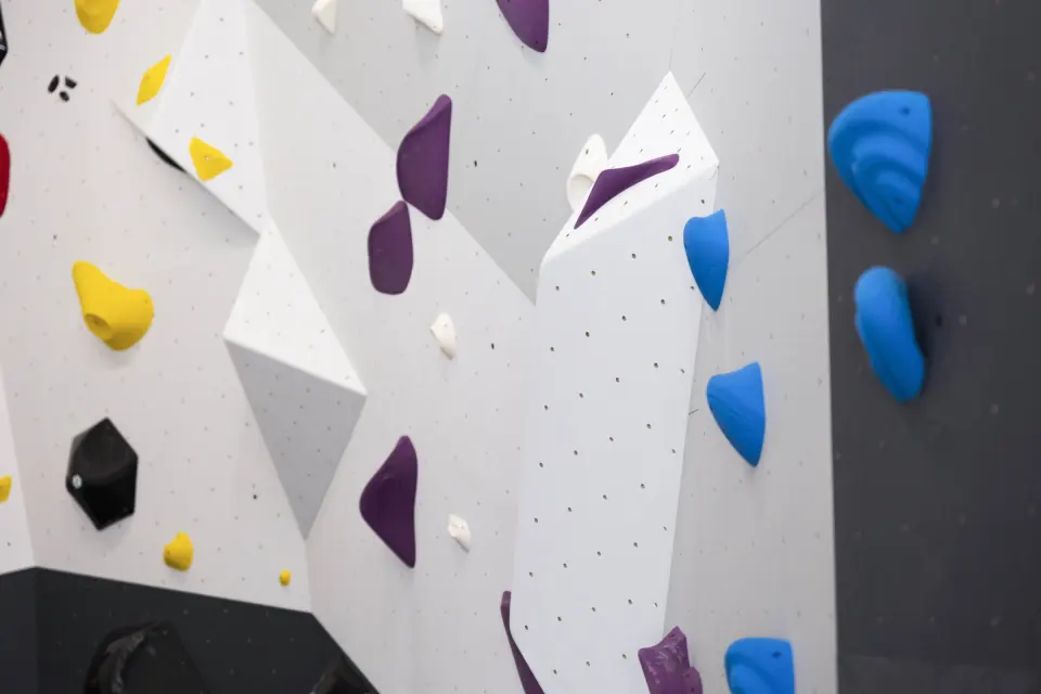 Purple, blue and yellow holds on angled panels and volumes