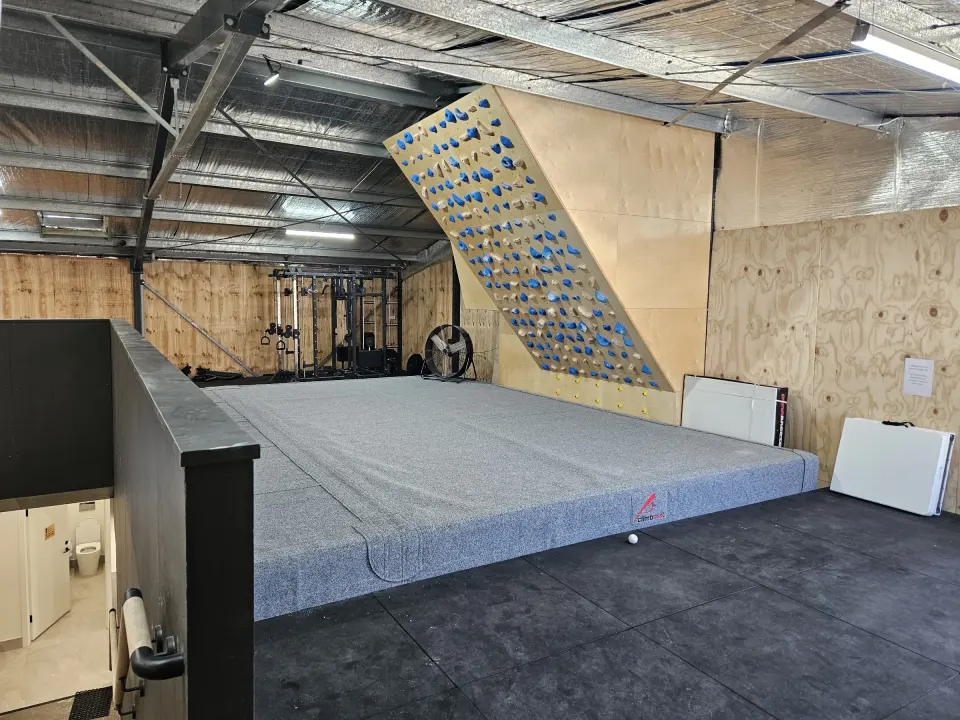 Upstairs training area with a steep board and weights rack