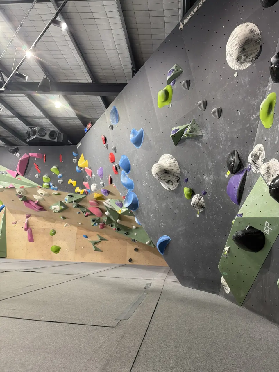 Overhanging grey wall above the plywood panels