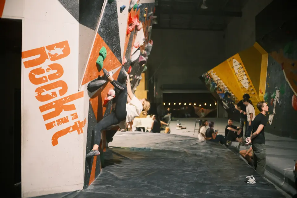 Long bouldering hall with the Rockit name painted on the wall