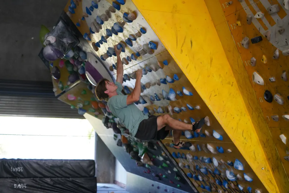 Climber on the steep MoonBoard