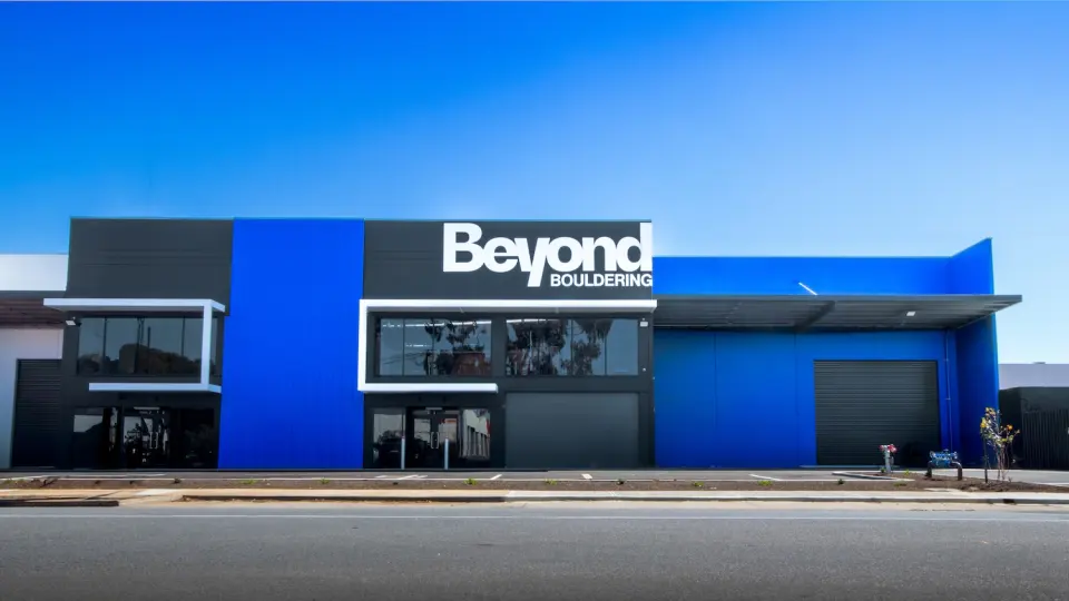 Blue and grey building on Walsh Street with the Beyond sign