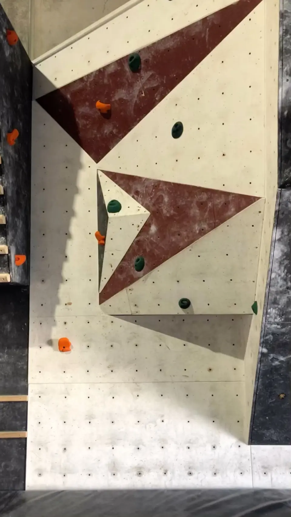 Wall panel with maroon triangle volumes and a fresh set of holds