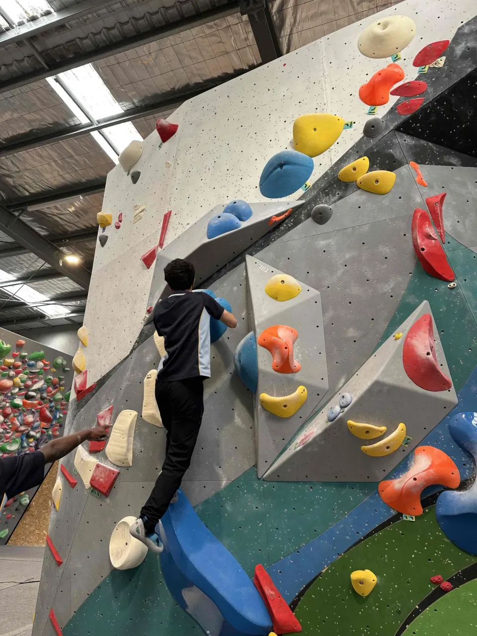 Climbers on an overhanging bouldering wall